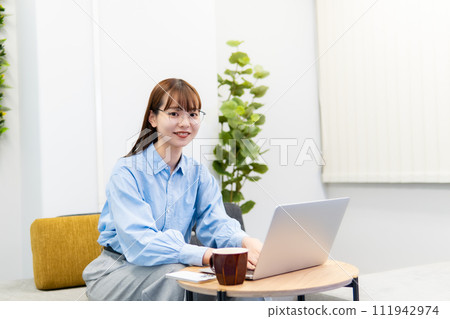A woman working on a laptop/working remotely A woman working on a laptop/working remotely 111942974
