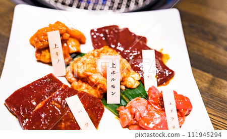 Eating offal on a grill 【 image of yakiniku 】 111945294