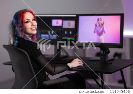 Smiling professional creative digital artist editing video at work in minimalistic office space 111945496