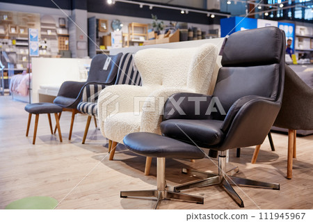 Furniture shop store assortment of modern soft armchair and poof Furniture shop store assortment of modern soft armchair and poof 111945967