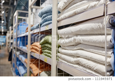 Shopping showcase rack with folded bedding items assortment with price tags Shopping showcase rack with folded bedding items assortment with price tags 111945971
