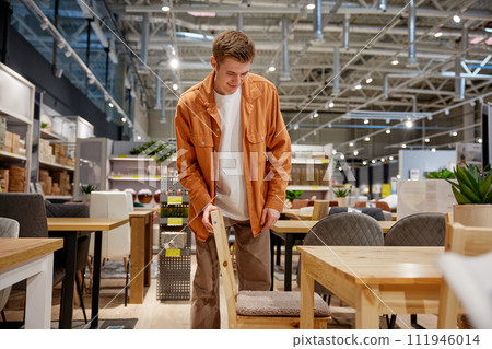 Young man couple choosing cupboard at store market 111946014