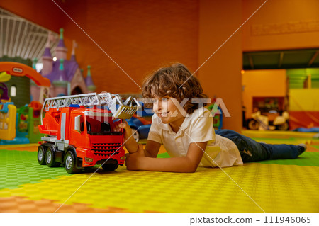 Boy child playing vehicle toys at kids care center 111946065