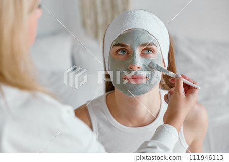 Closeup young woman relaxing during homemade skincare procedure 111946113