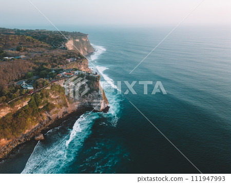 Aerial view of Pura Luhur Uluwatu Temple and the Cliffs at sunset 111947993
