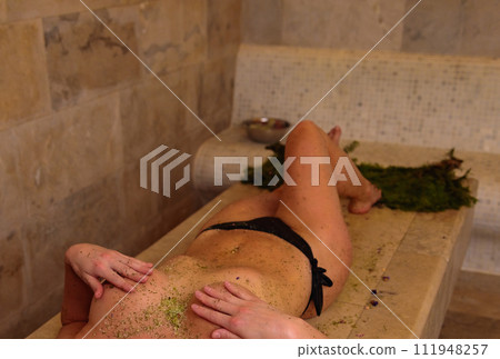 Girl in bikini relaxes after massage in hammam 111948257