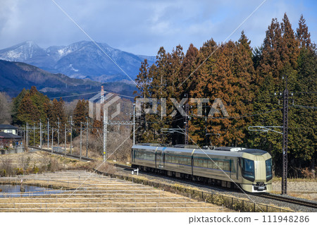 Liberty express train running with winter mountains in the background 111948286