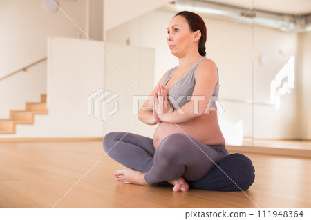 Pregnant woman is engaged in yoga. Easy pose or sukhasana 111948364