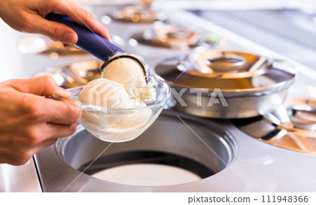 Ball of vanilla ice cream in ice cream razor in cafe Ball of vanilla ice cream in ice cream razor in cafe 111948366