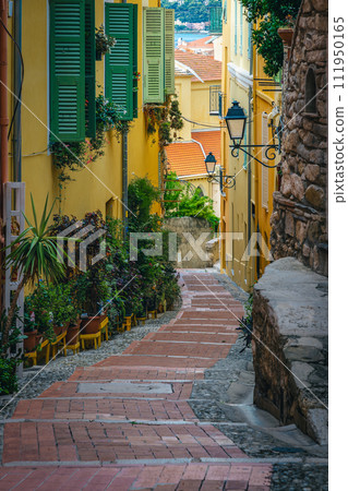 Narrow street with stairs and green ornamental plants, Menton, France Narrow street with stairs and green ornamental plants, Menton, France 111950165
