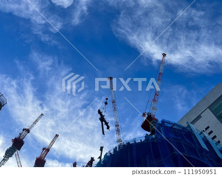 Urban landscape with blue sky and large-scale construction site/Under construction Urban landscape with blue sky and large-scale construction site/Under construction 111950951
