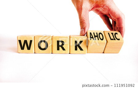 Work or workaholic symbol. Concept words Work or Workaholic on wooden cubes. Beautiful white table white background. Businessman hand. Business work or workaholic concept. Copy space. 111951092