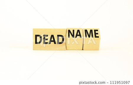 Deadname or name symbol. Concept words Deadname or Name on beautiful wooden blocks. Beautiful white table white background. Business, deadname or name concept. Copy space. Deadname or name symbol. Concept words Deadname or Name on beautiful wooden blocks. Beautiful white table white background. Business, deadname or name concept. Copy space. 111951097