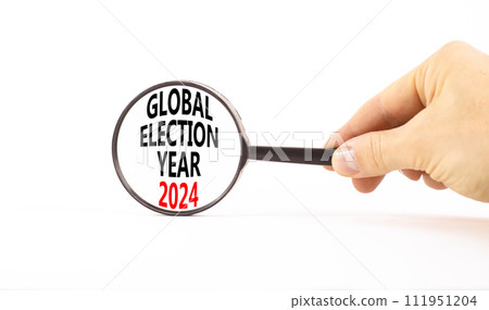 Global election year 2024 symbol. Concept words Global election year 2024 on beautiful magnifying glass. Beautiful white background. Voter hand. Business Global election year 2024 concept. Copy space 111951204