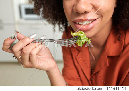 Cropped image of smiling woman eating green salad for lunch 111951454