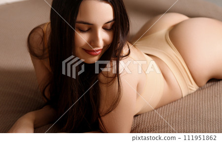 Cute asian woman laying in bed. Looking from 111951862