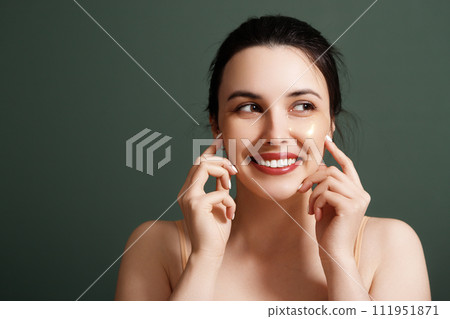 Girl puts on under eye patches, cosmetic treatment 111951871