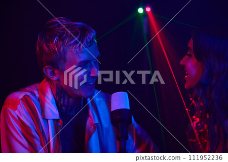 Happy couple enjoying singing in karaoke on fist date 111952236