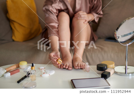 Woman applying nail polish when doing pedicure at home Woman applying nail polish when doing pedicure at home 111952944