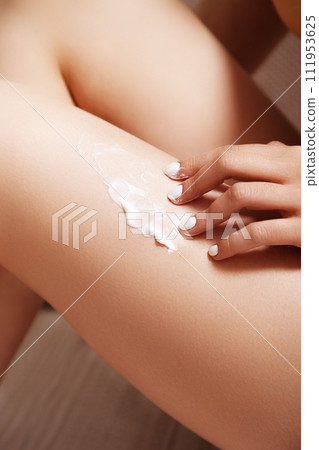 Body care. Woman applying cream on legs and 111953625