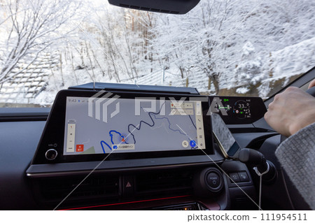 Driver's seat of a car driving on a snowy road Driver's seat of a car driving on a snowy road 111954511