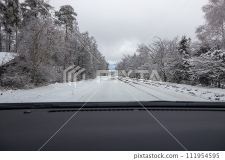 View from a car driving on a snowy road 111954595