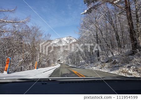 View from a car driving on a snowy road 111954599