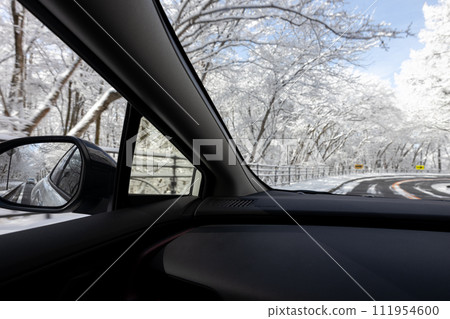 View from a car driving on a snowy road 111954600