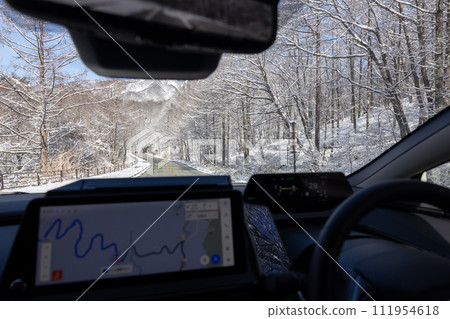 View from a car driving on a snowy road View from a car driving on a snowy road 111954618