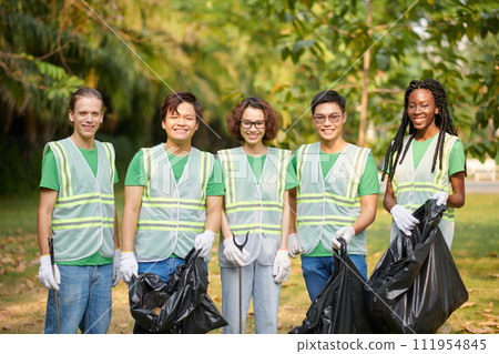 Diverse group of volunteers standing with bags of garbage they collected together Diverse group of volunteers standing with bags of garbage they collected together 111954845