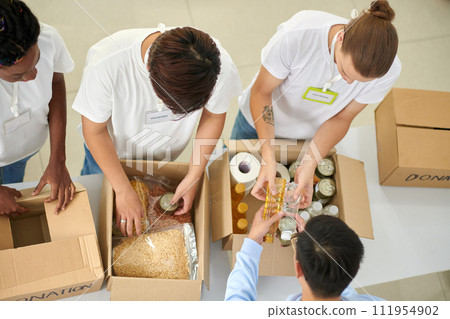 Young people volunteering on weekend, collecting food for homeless people 111954902