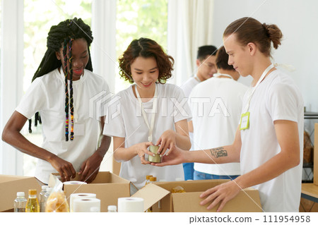 Diverse group of friends working as volunteers in charity organization 111954958
