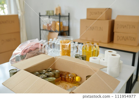 Warehouse of charity organization with food, clothes and toiletries Warehouse of charity organization with food, clothes and toiletries 111954977