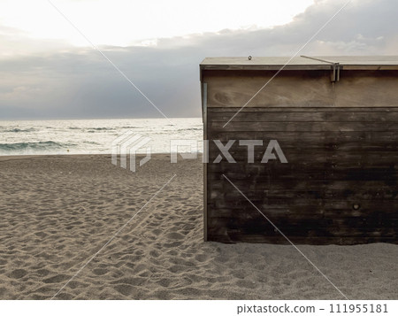 A solitary wooden cabin door stands on a tranquil beach, A solitary wooden cabin door stands on a tranquil beach, 111955181