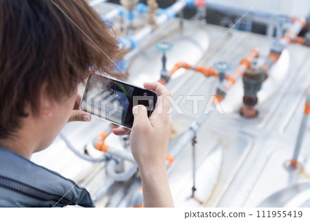 On-site supervisor taking on-site photos 111955419