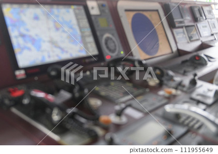 Navigational control panel and VHF radio. Working on the ship's navigational bridge. Blurred image. 111955649