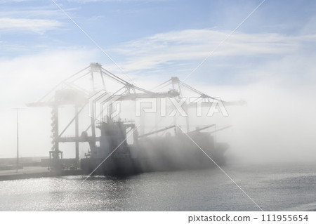 Container ship in port, strong fog. Foggy weather. Bad visibility. Container ship in port, strong fog. Foggy weather. Bad visibility. 111955654