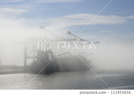 Container ship in port, strong fog. Foggy weather. Bad visibility. Container ship in port, strong fog. Foggy weather. Bad visibility. 111955656