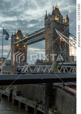 View of famous Tower bridge and skyline with reflections in the river thames just after sunset. 111955880