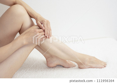 woman holding her feet woman holding her feet 111956164