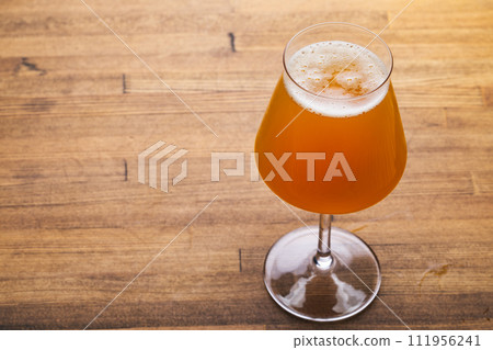 Craft beer in tulip glass on wooden table 111956241