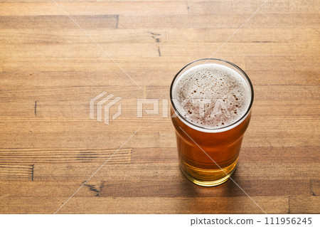 Craft beer in pint glass on a wooden table 111956245