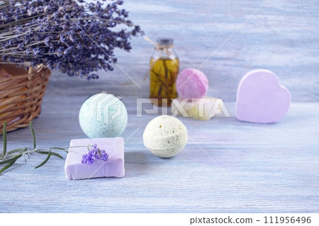 Lavender soap, fragrance oil, foam bombs and fresh lavender flowers on a wooden background, bath products 111956496