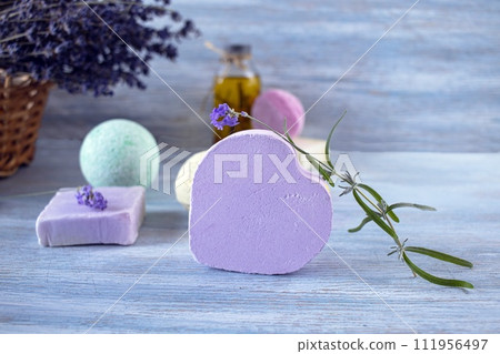 Lavender soap, fragrance oil, foam bombs and fresh lavender flowers on a wooden background, bath products 111956497