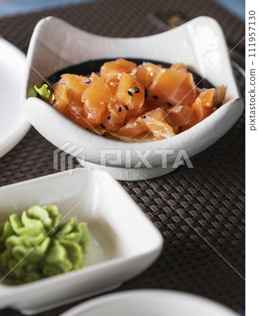 A bowl of delicious salmon tartare with sesame and herbs A bowl of delicious salmon tartare with sesame and herbs 111957130