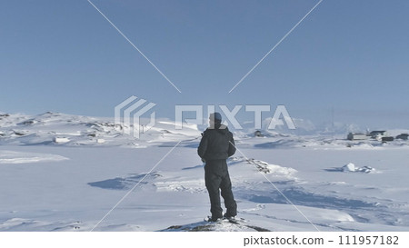 Man Snow Landscape Aerial Tracking View. Drone Fly Around Person Standing in Ice Covered Antarctic Winter Mountain Edge. Extreme Dream Expedition to Antarctica Station Flight Footage Shot in HD (FHD). Man Snow Landscape Aerial Tracking View. Drone Fly Around Person Standing in Ice Covered Antarctic Winter Mountain Edge. Extreme Dream Expedition to Antarctica Station Flight Footage Shot in HD (FHD). 111957182