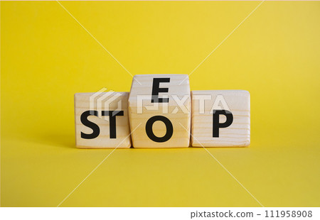 Step vs Stop symbol. Wooden cubes with words Stop and Step. Beautiful yellow background. Step vs Stop and business concept. Copy space 111958908