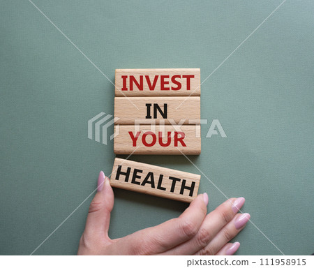 Invest in your Health symbol. Concept words Invest in your Health on wooden blocks. Businessman hand. Beautiful grey green background. Business and Invest in your Health concept. Copy space. 111958915