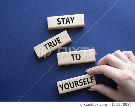 Stay True to Yourself symbol. Wooden blocks with words Stay True to Yourself. Businessman hand. Beautiful deep blue background. Business and Stay True to Yourself concept. Copy space. Stay True to Yourself symbol. Wooden blocks with words Stay True to Yourself. Businessman hand. Beautiful deep blue background. Business and Stay True to Yourself concept. Copy space. 111958925