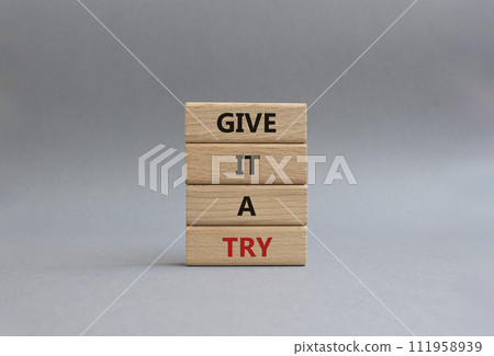 Give it a try symbol. Concept words Give it a try on wooden blocks. Beautiful grey background. Business and Give it a try concept. Copy space. 111958939